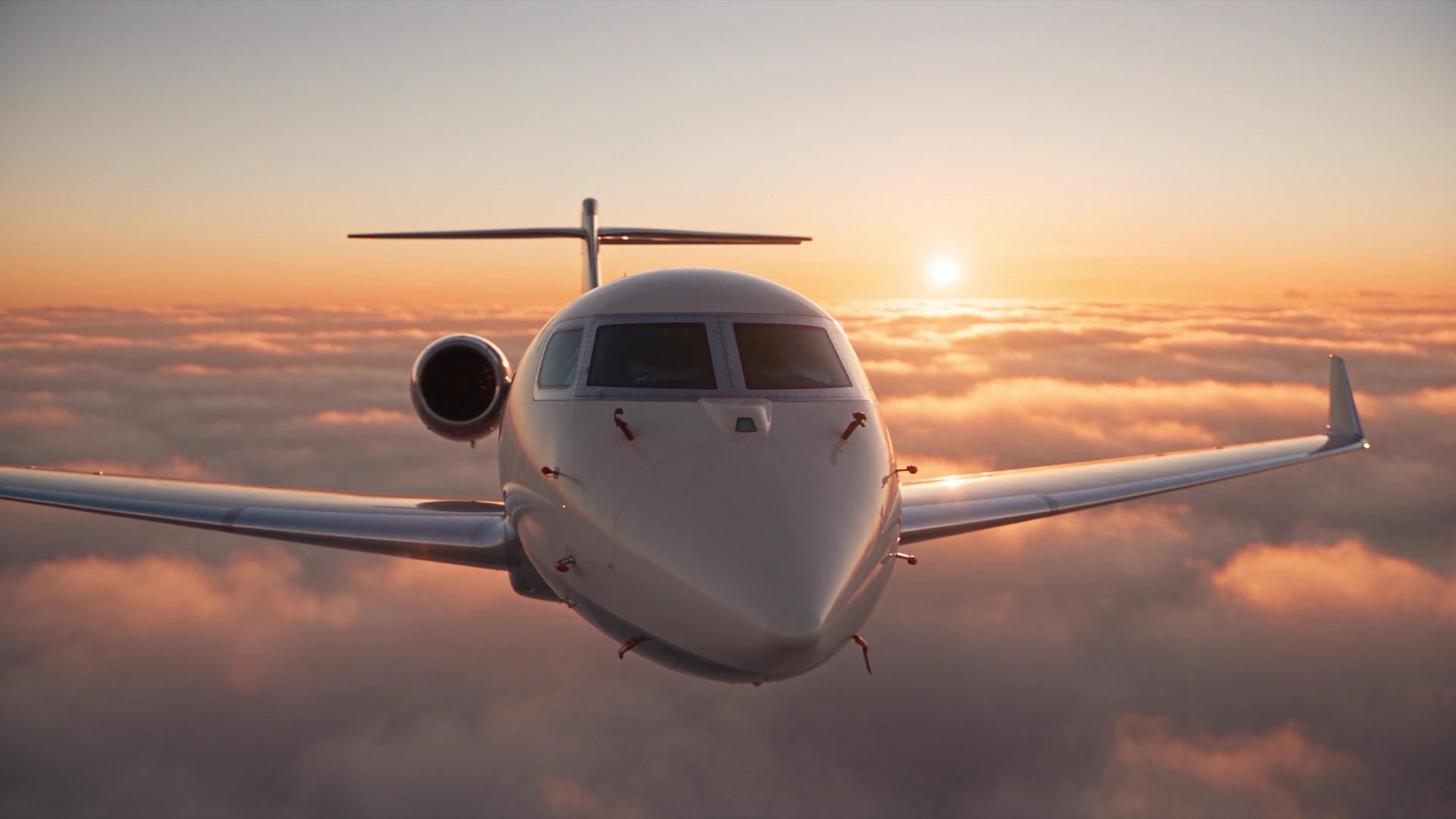 Pearl-white private jet flying above clouds at sunrise